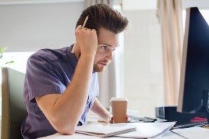 guy looking stressed at laptop