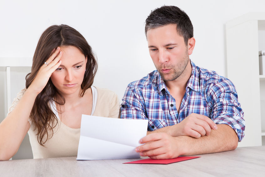 couple looking at paper worried