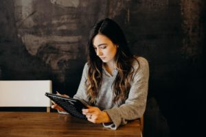 woman looking at tablet